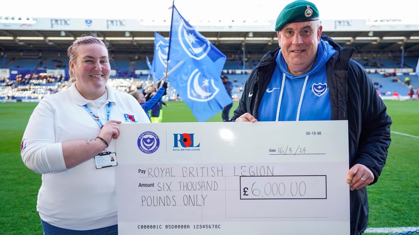 A cheque being presented to the Royal British Legion at Fratton Park
