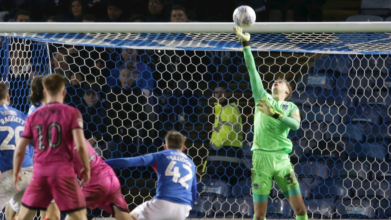 Alex Bass makes a save for Pompey against Rochdale