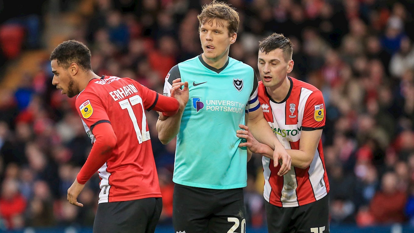 Sean Raggett in action for Pompey at Lincoln City