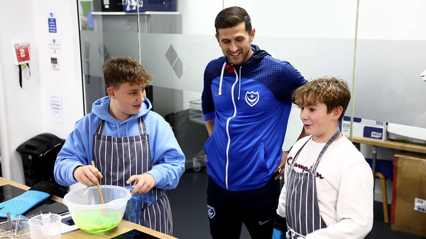 John Mousinho takes part in a baking exercise with Pompey in the Community